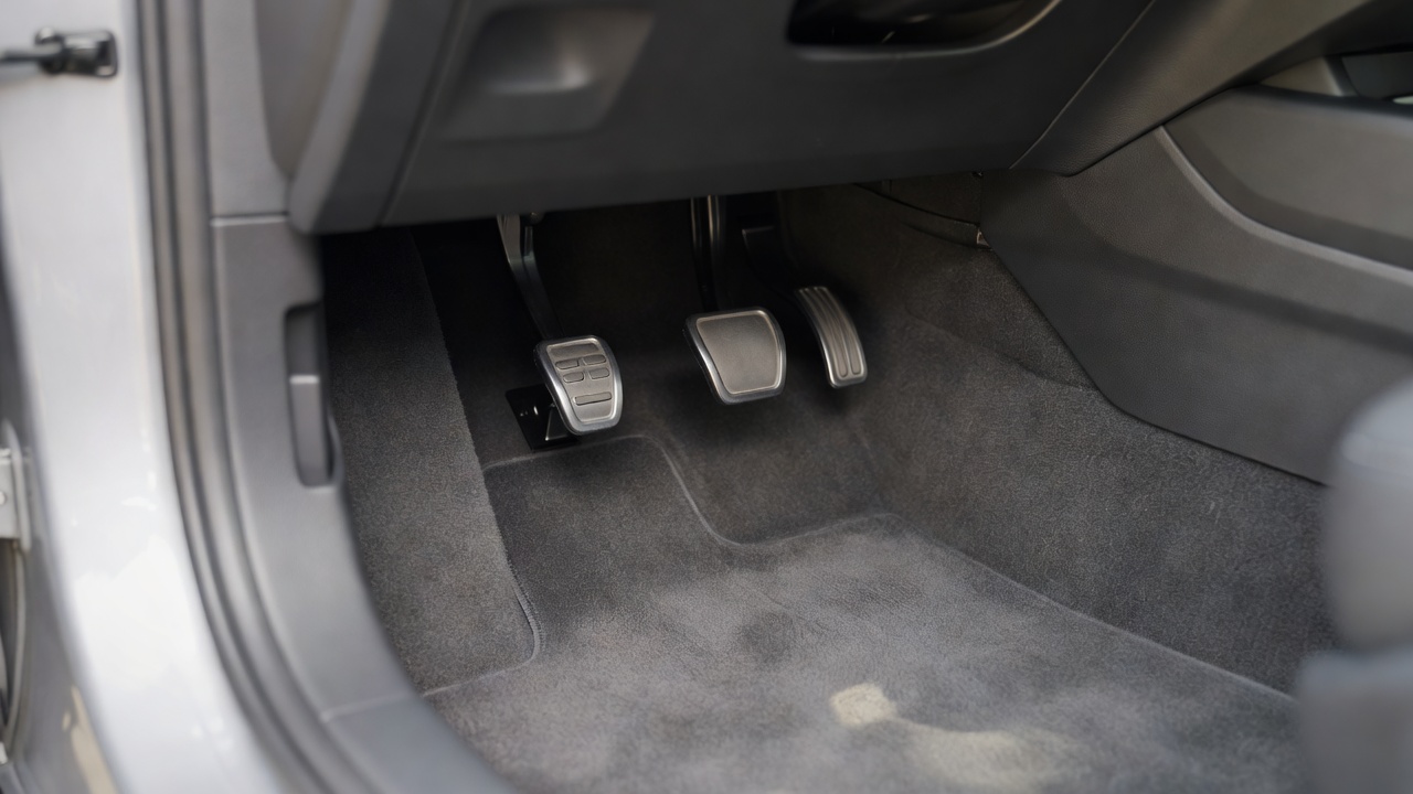 The pedals in the footwell of a manual car