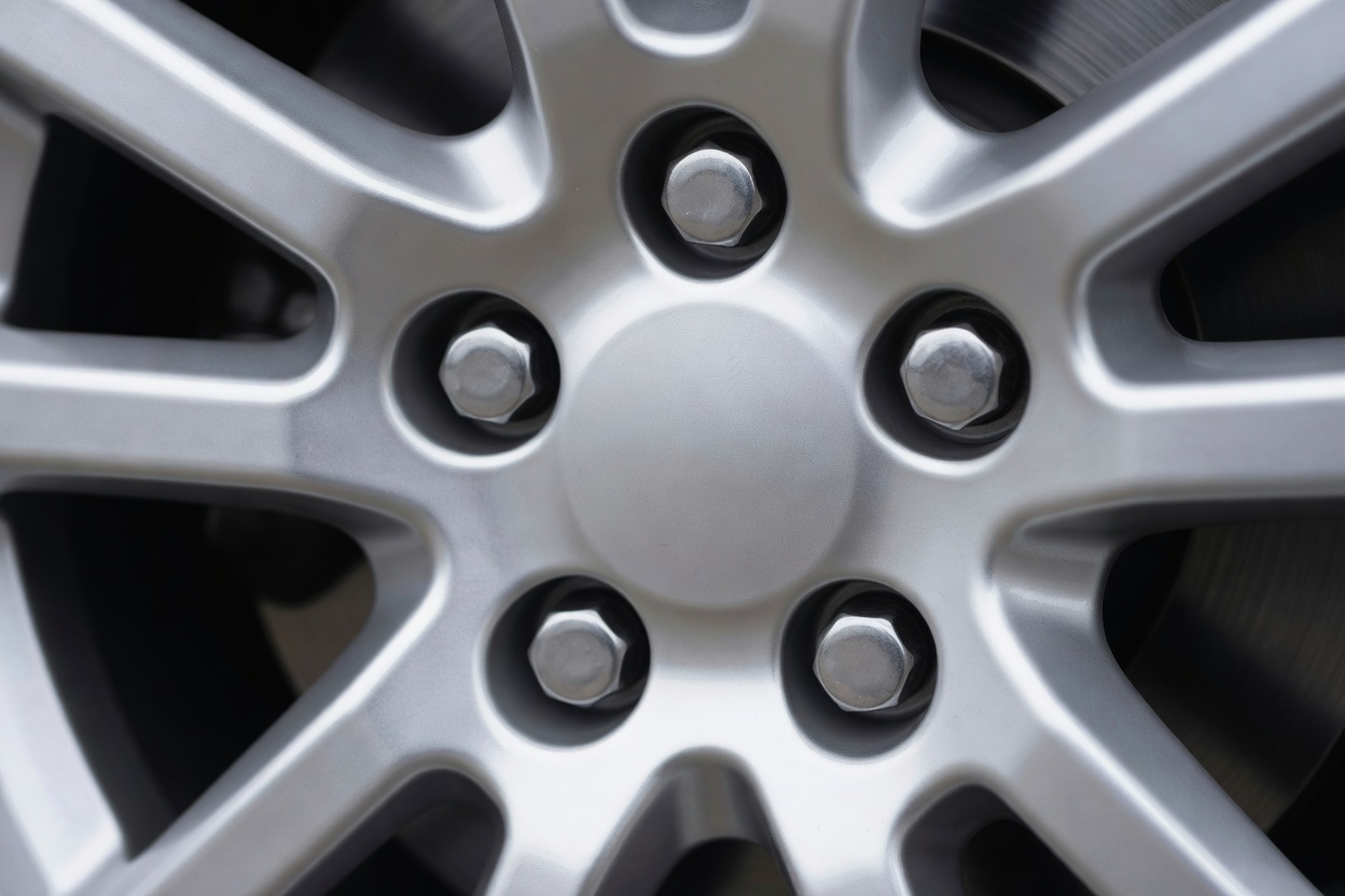 The centre of an alloy wheel showing the wheel nuts